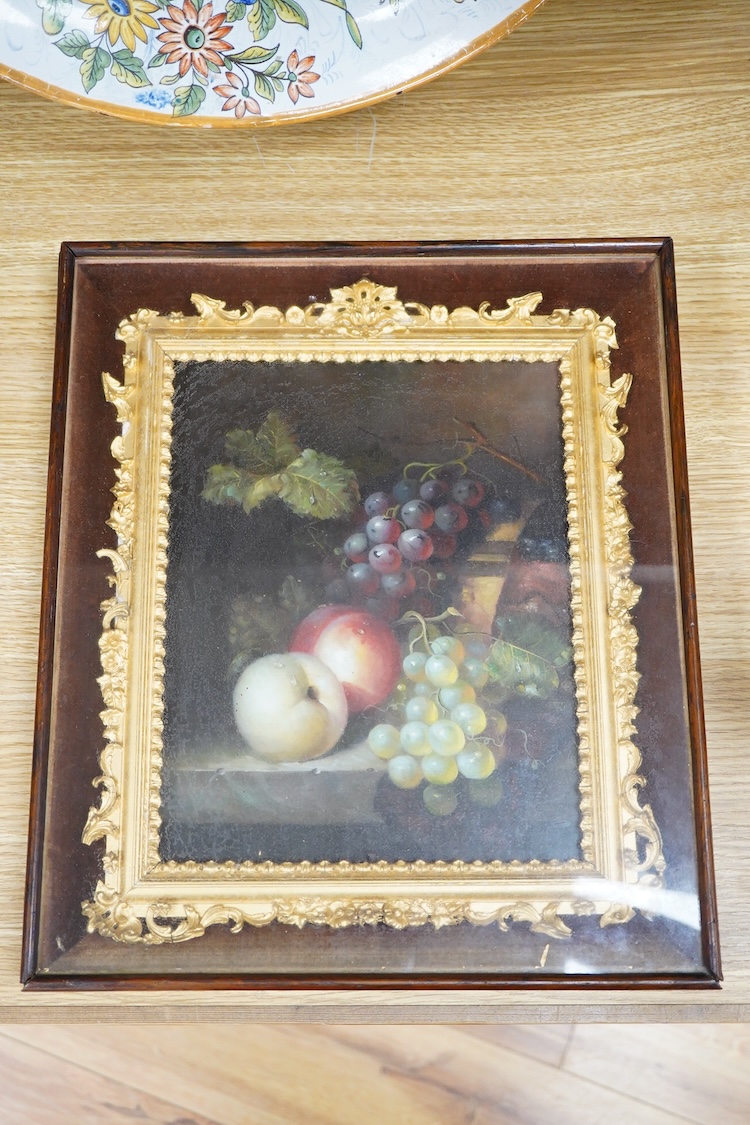 A painted porcelain plaque, still life of fruit, housed in an ornate gilt frame, overall 35 x 30cm